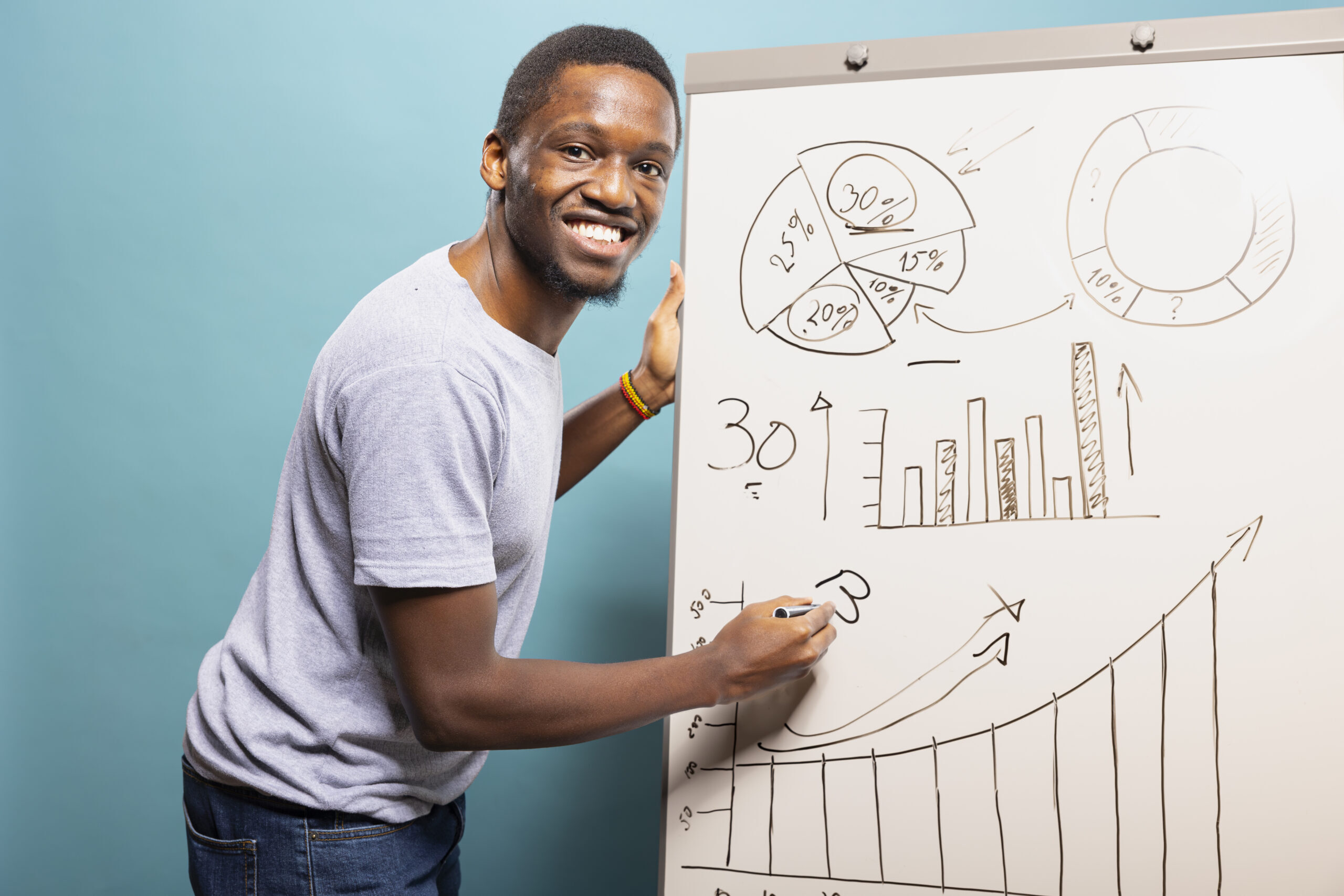 Smiling Black man explaining a chart while presenting the top 10 growth marketing services for 2025.